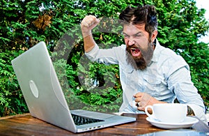 Brutal bearded hipster need coffee break. stressed man working on laptop. Frustrated office worker. aggressive