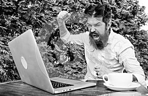 Brutal bearded hipster need coffee break. stressed man working on laptop. Frustrated office worker. aggressive