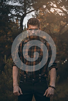 Brutal bearded man in forest outdoor photo
