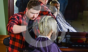 brutal bearded man at hairdresser salon with master, hair look