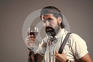 brutal bearded man hipster drinking wine, wine tasting