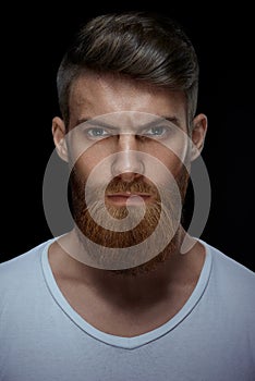 Brutal bearded man in a white T-shirt photo