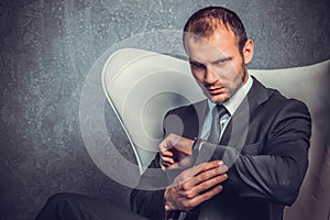 Brutal businessmen in suit with tie sitting on chair