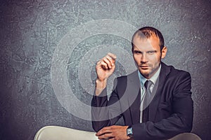 Brutal businessmen in suit with tie sitting on chair