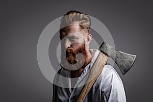 Brutal Caucasian hipster with moustache. Bearded man isolated on grey. Bearded man hold ax. Hair and beard care