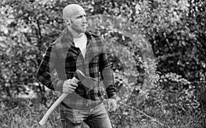 Brutal male in forest. Power and strength. Lumberjack carry ax. Bald woodsman. Harvest firewood. Hike vacation. Hike in