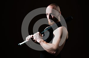 Brutal man with baseball bat for fighting, concept of men power and strong. Dangerous man with serious emotion.