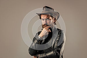 Brutal man cowboy hat leather jacket, making decision concept