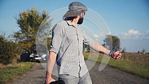 Brutal man hitchhiking in countryside.