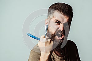 Brutal man with vintage straight razor. Barber shop concept. Vintage barbershop and shaving