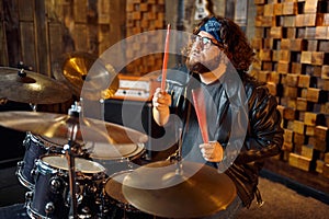 Brutal musician behind the drum kit on stage