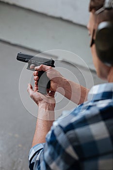 Brutal professional marksman reloading his gun photo
