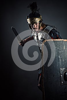 Brutal Roman legionary with sword and shield in hands