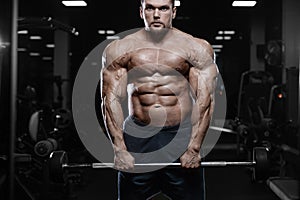 Brutal strong bodybuilder athletic men pumping up muscles with d