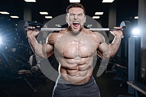 Brutal strong bodybuilder athletic men pumping up muscles with d