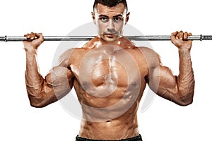 Brutal strong muscular bodybuilder athletic man pumping up muscles with barbell on white background. Workout