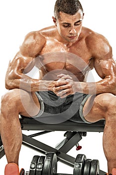 Brutal strong muscular bodybuilder athletic man pumping up muscles on white background. Workout bodybuilding concept
