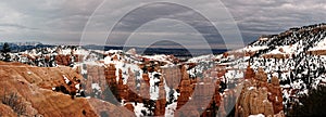 Bryce canyon in Utah panorama in overcast winter day with orange rocks and snow