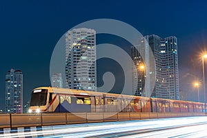 BTS sky train with long exposure light on Taksin Bridge, Bangkok, Thailand