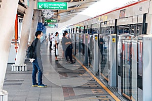 BTS Skytrain Bangkok passengers wait for the train on the platform.