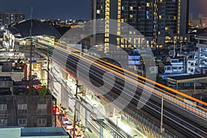 BTS Skytrain, Electric train, running on the way with business office buildings on the background, Railroad with motion