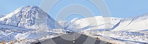 Buachaille Etive Mor and empty road covered in snow during winter