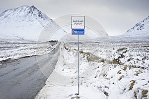 Buachaille Etive Mor mountain and empty road covered in snow during winter