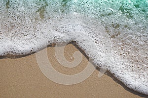 Bubble foam from waves sea on the sand beach