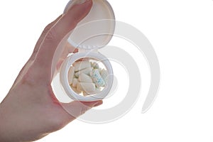 Bubble Gum. Chewing gum pads in a jar in hand isolated on a white background .Chewing gum with mint