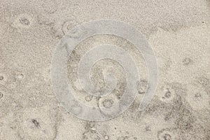 Bubble like pattern on sand beach background