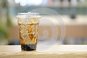 Bubble Milk Tea - A plastic glass of fresh milk with black sugar syrup Kuromitsu and hot black pearl Boba.