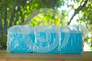 Bubble plastic wrap white gallon inside is an blue alcohol gel for hand washing and sanitizing