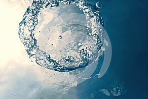 Bubble ring Underwater ascends towards the sun.