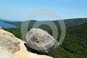 Bubble Rock on top of the South Bubble Mountain and Jordan Pond at Acadia National Park in Maine