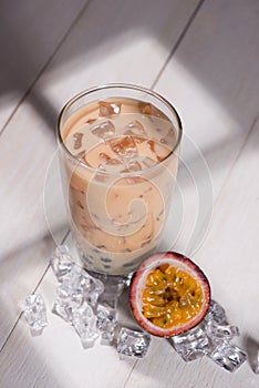 Bubble tea. Homemade Passion Fruit Milk Tea with Pearls on wooden table.