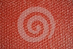 Bubble wrap on a red background. Texture and background