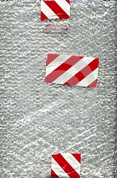 Bubble wrap with white and red tape