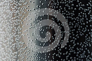 Bubbles of air under water, black background. Beautiful background texture