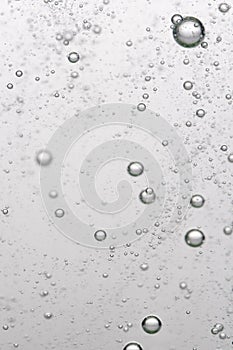 Bubbles of air in water on a white background. Macro.