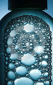 Bubbles of different sizes crowded in a transparent bottle photo