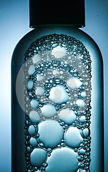 Bubbles of different sizes crowded in a transparent bottle photo