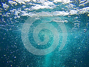 Bubbles from divers underwater shooting surfaces watersports