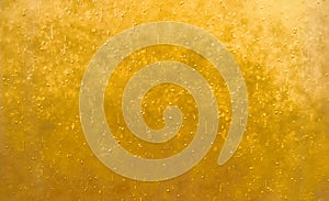 Bubbles floating in the liquid yellow drink, abstract image.