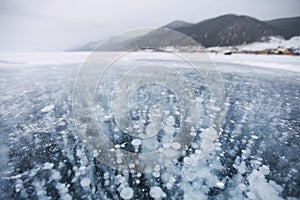 Bubbles in ice. Baikal lake. Winter landscape