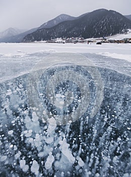 Bubbles in ice. Baikal lake. Winter landscape