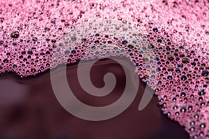 Bubbles of red wine closeup. Alcoholic background