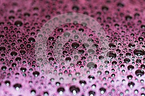Bubbles of red wine closeup. Alcoholic background
