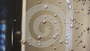 Bubbles rising at the surface of a glass bottle