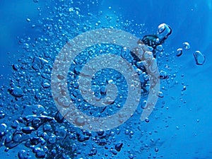 Bubbles from Scuba Exhale under Blue Ocean