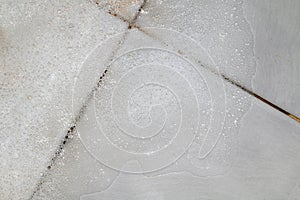 Bubbles soap detergent with scrubbing the bathroom floor dirt wet, Foam white bubble from shampoo washing on Tiled floor top view